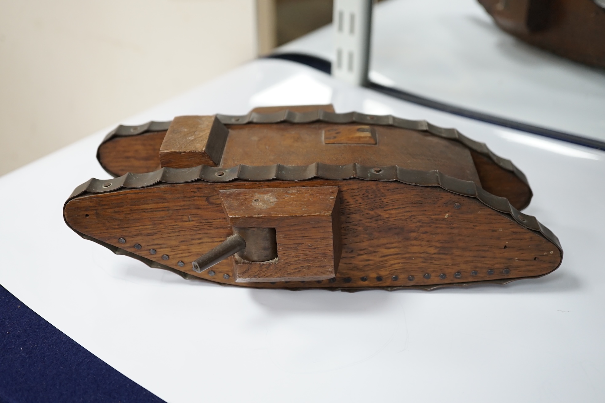 A Trench art tank, a parquetry box including paste and silver brooch and mixed collectables, box 30cm x 20cm. Condition - tank, box and brooch good, other contents variable